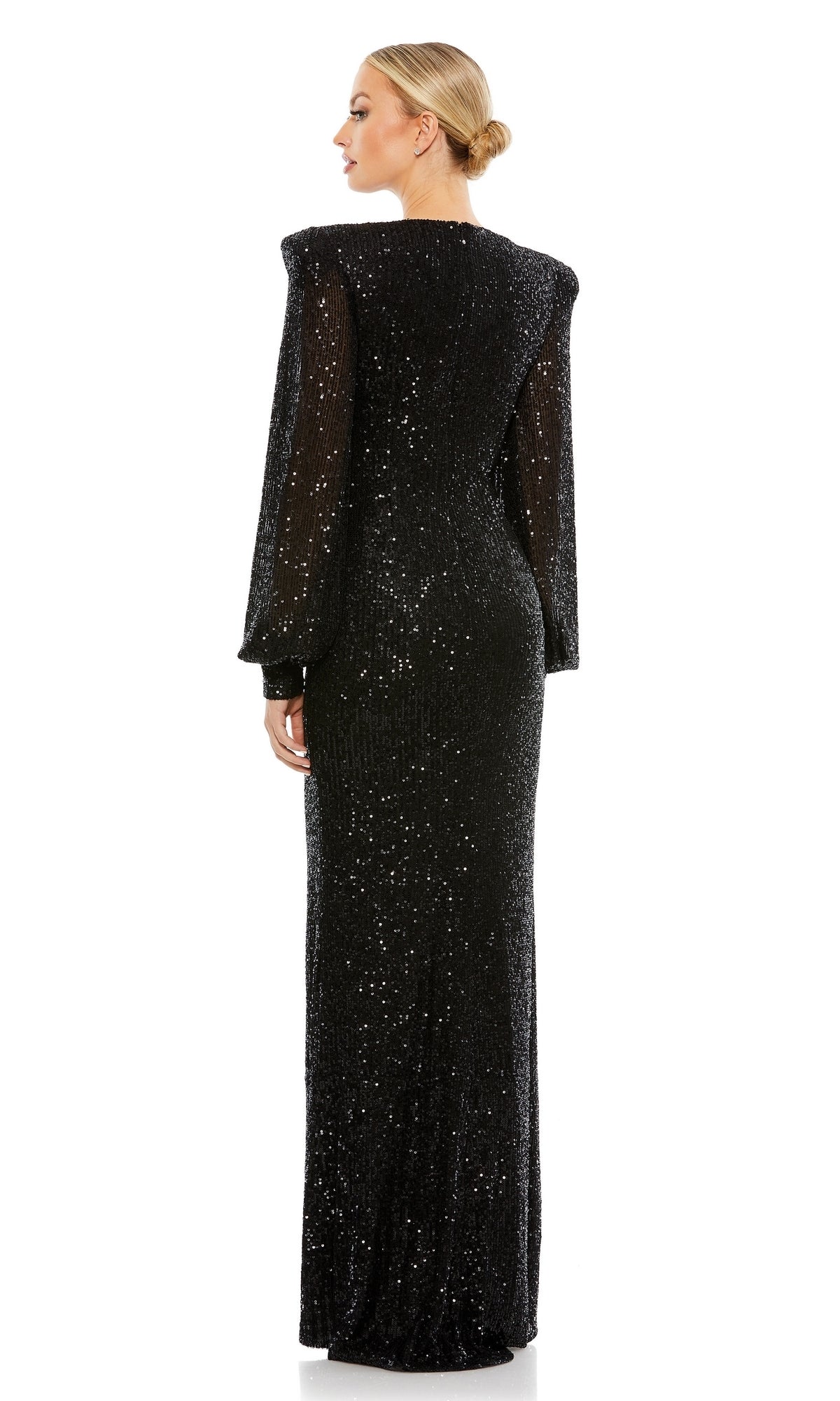 A woman with a low bun faces away, modeling the Long Formal Dress 26722 by Mac Duggal—featuring long sleeves, sequin fabric, and padded shoulders—against a plain white background.